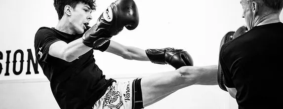 Muay Thai kick thrown during pad work at Mission BJJ in Mission, BC