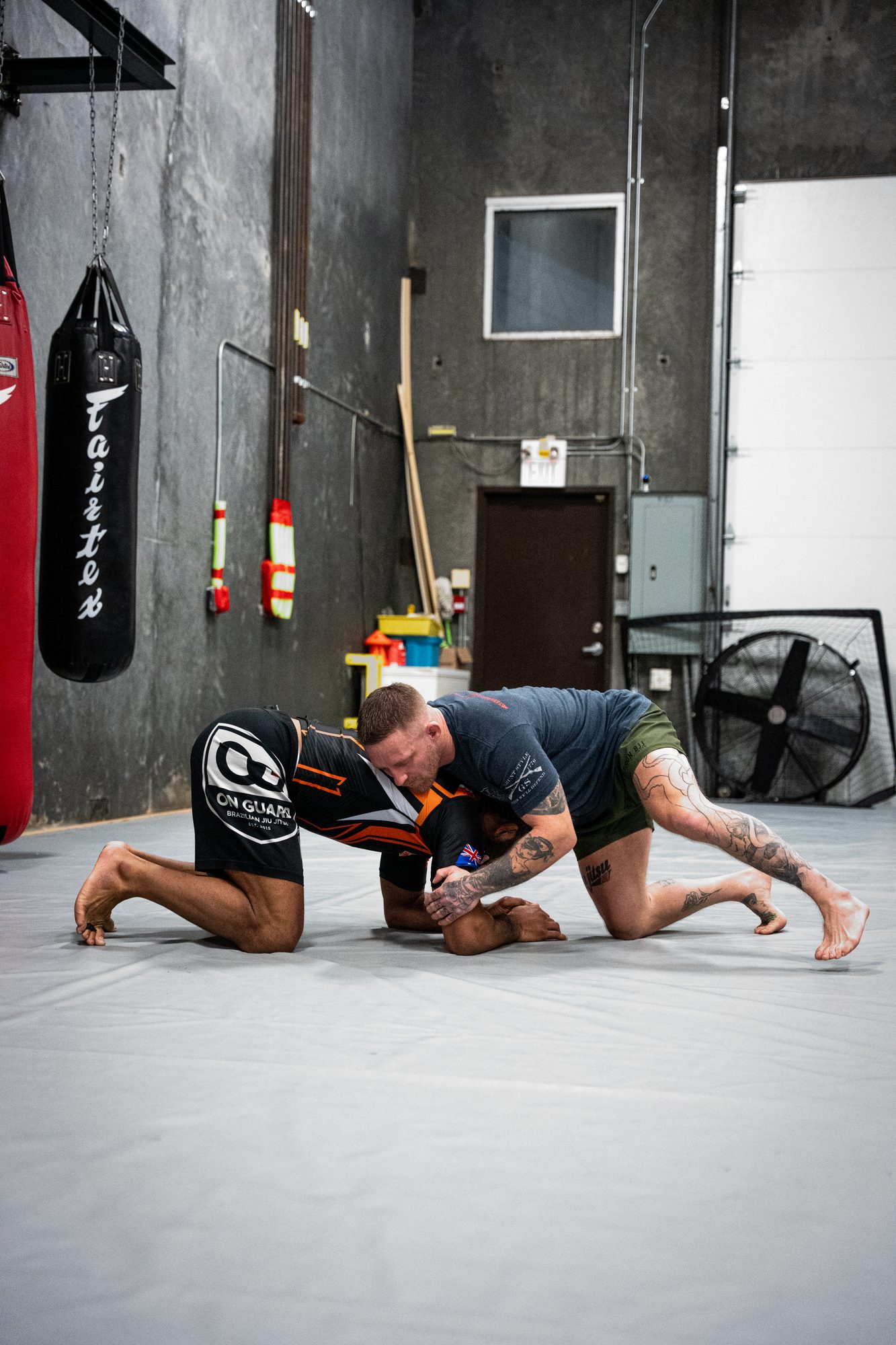 Two grapplers drilling No Gi techniques on the mats at Mission BJJ in Mission, BC